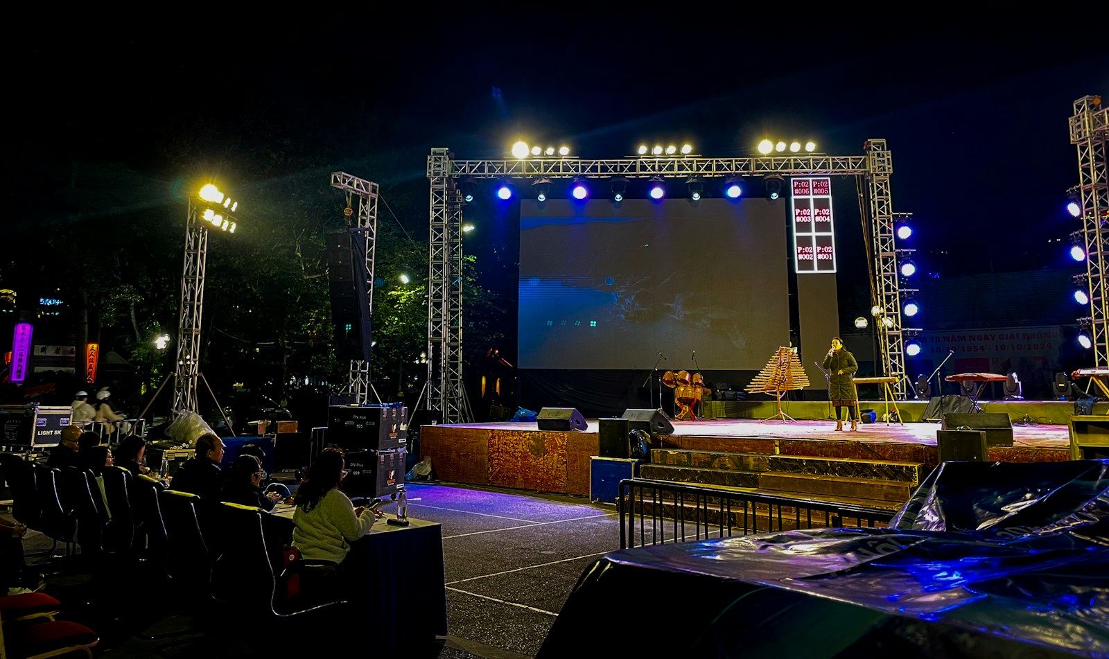 Outdoor event stage with lighting rigs